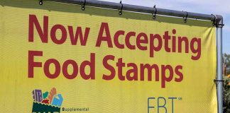 Yellow sign now accepting food stamps EBT SNAP
