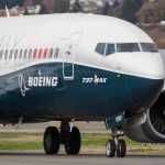 Boeing 737 MAX airplane on runway.