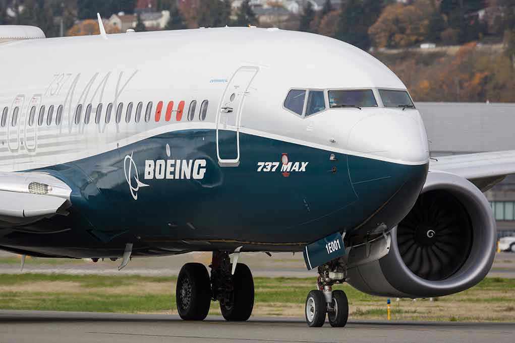 Boeing 737 MAX airplane on runway.
