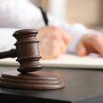 Judge SIDES With Kirk Assassin- Unexpected Decision Judges gavel on desk with person writing.