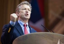 Rand Paul WARNS Trump: MAGA Revolt Coming Man in a suit passionately delivering a speech at a podium