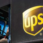 UPS delivery truck driver at traffic light