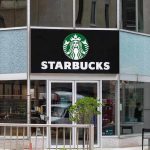 Nationwide Strikes Rock Starbucks – Corporate Assault! Starbucks storefront with glass doors and logo