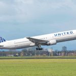 Bomb Threat Diverts Flight Mid-Air: Emergency Landing! United airplane taking off from a runway.