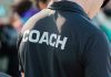 Person wearing a shirt labeled Coach.
