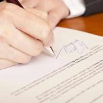 Trump Signature SCANDAL – Biden 2.0? Hand signing a document with a pen.