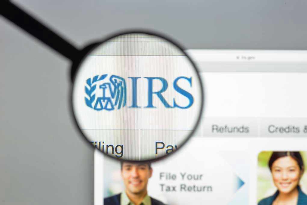 Magnifying glass over IRS website.