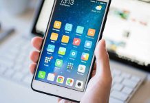 A person holding a smartphone displaying various mobile applications