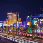 Vibrant view of the Las Vegas Strip at night with neon lights and traffic
