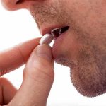 Deadly Bacteria Cornered: A New Antibiotic Emerges Close up of a man preparing to take a pill