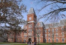 Historic university building with students walking in front during autumn
