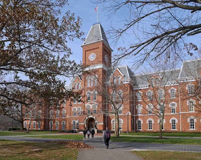 shutterstock_238536373.jpg Historic university building with students walking in front during autumn