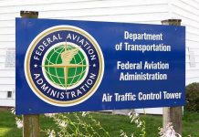 FAA Staffing Crisis – Travel Chaos Imminent! Sign for the Federal Aviation Administration at an air traffic control tower