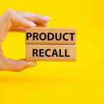 Terrifying Recall His MAJOR Groceries – Do Not Consume! Hand holding Product Recall blocks on yellow background.