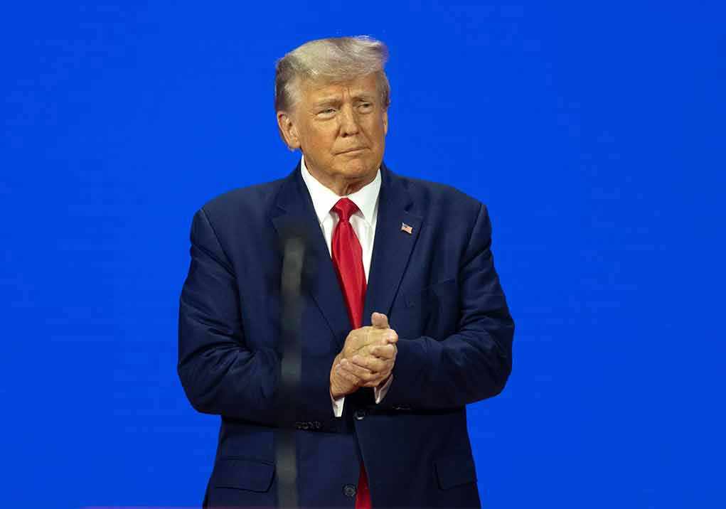 Man in a suit with a blue background.