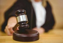 Judge striking gavel in a courtroom.