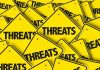 Yellow warning signs with the word THREATS.
