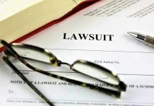 Nepo Baby Sued by Own Lawyers Lawsuit document with glasses, pen, and book.