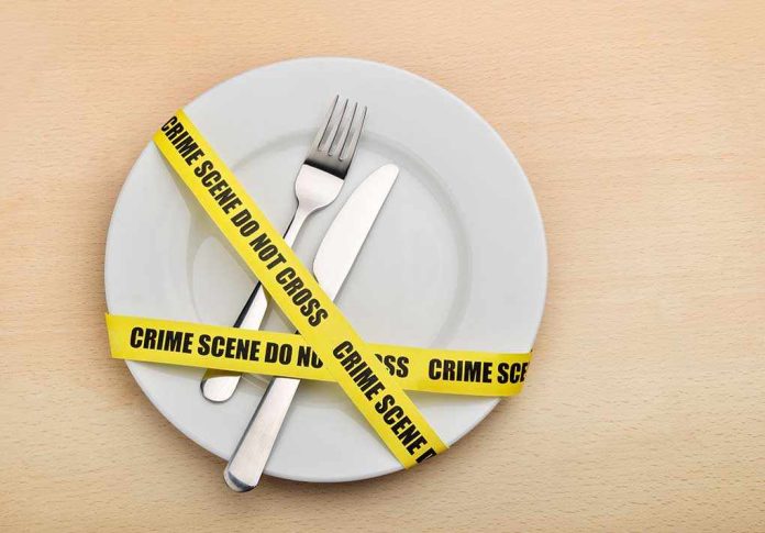 shutterstock_132445160.jpg A plate with a fork and knife wrapped in yellow crime scene tape