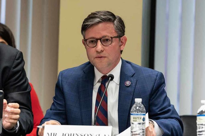 A public official speaking at a meeting with a nameplate in front of him