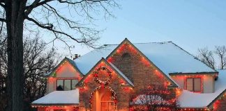 A beautifully decorated house with Christmas lights in a snowy setting