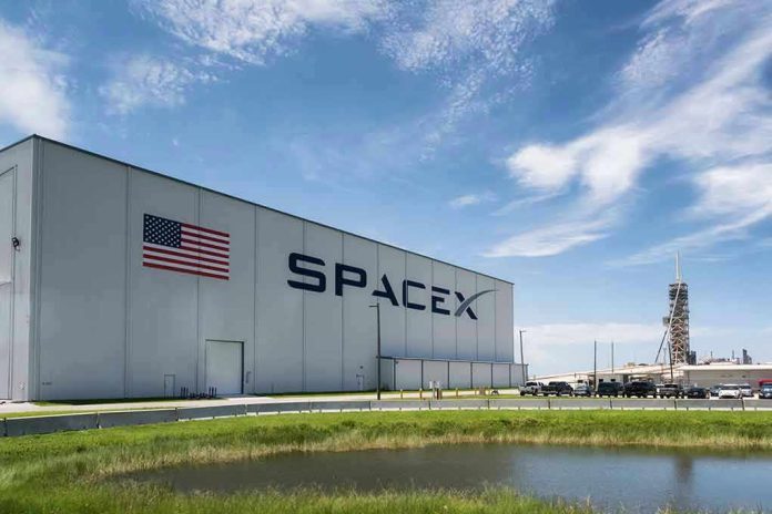 SpaceX building with American flag and launch pad.