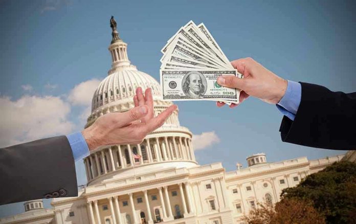 Hands exchanging money in front of Capitol building.