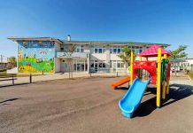 Colorful playground slide in front of a building.