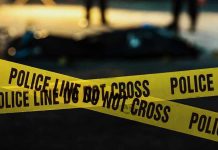 Police tape marking a crime scene at night.