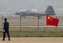 Espionage Scandal ROCKS China’s Military Elite Jet with 31001 marking behind barbed wire fence.