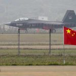 China TESTS Trump With Massive Taiwan Assault Jet with 31001 marking behind barbed wire fence.