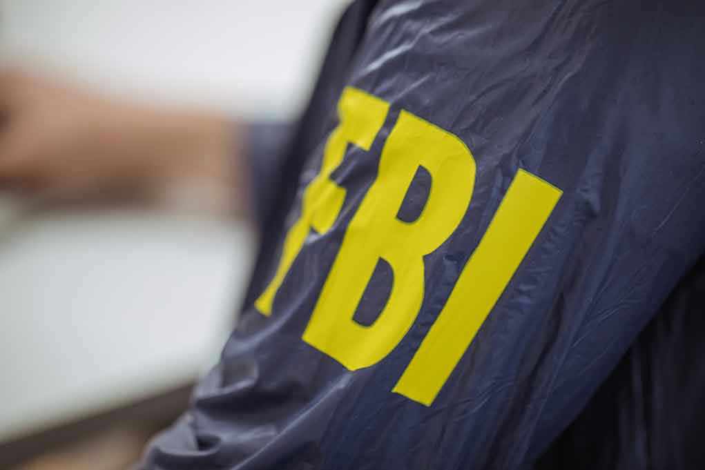 Jacket with FBI letters in yellow.