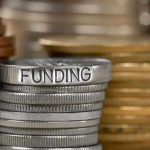 Taxpayer Money VANISHES in Bill Debate Stack of coins labeled funding with other coins stacks