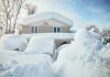 A house surrounded by deep snow drifts after a heavy snowfall