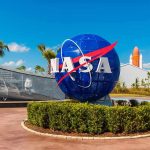 Hydrogen Leak Halts NASA Moon Countdown NASA logo sculpture with spaceship and palm trees.