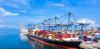 Container ship docked at a busy industrial port.
