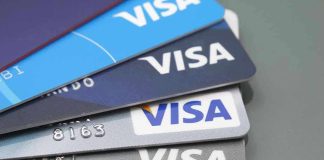 Stacked Visa credit cards in various colors.