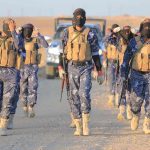 Volcano Eruption Intensifies — Ash Towering Skyward Camouflaged soldiers wearing masks and vests walk in desert.