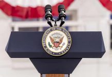 Vice Presidential podium with microphones and emblem.