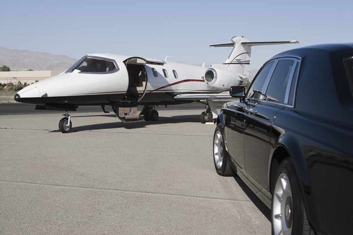 A private jet parked at an airport with a luxury car in the foreground