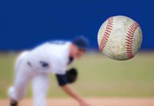 HORRIFYING Driver RAMS YOUTH Baseball Team A baseball in mid-air with a pitcher in the background preparing to throw