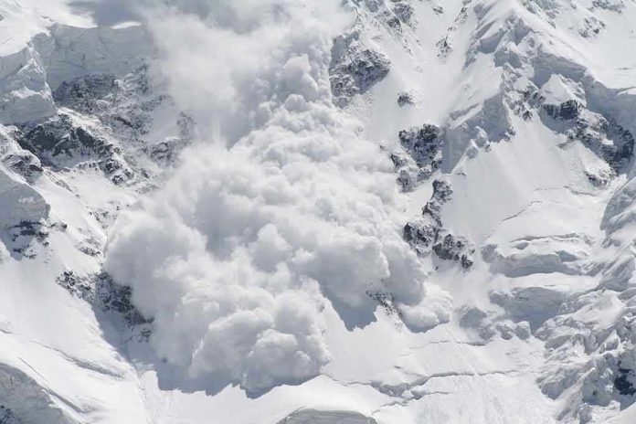 An avalanche occurring on a snowy mountain slope