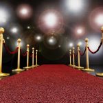 Anti-ICE Grammys Hijack Music Night A red carpet lined with gold stanchions and ropes under bright spotlights