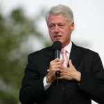 Oversight Committee DROPS Clinton Bombshell A man in a suit speaking into a microphone at an outdoor event