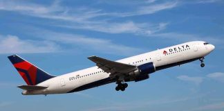 Delta Airlines airplane taking off against a blue sky