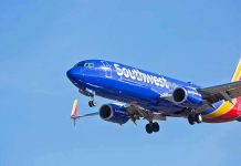 Tactical Cops STORM Southwest Airplane Southwest Airlines plane flying in blue sky.
