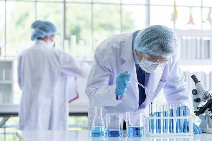 1365781304 Scientists working in a laboratory with test tubes