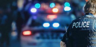 Deputies Spot Impairment—Then Find This Police officer with patrol car and flashing lights.