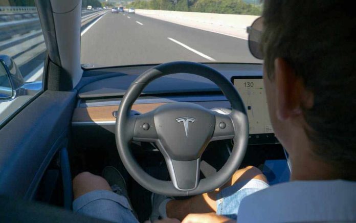 1725105379 Man using autopilot mode in a Tesla car.