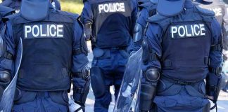 Abolish Police Chant—Cops Shield Protesters Police officers in riot gear with shields.